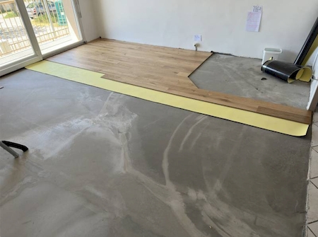 Pose de parquet contrecollé avec emplacement pour un poêle dans un salon à Lentilly